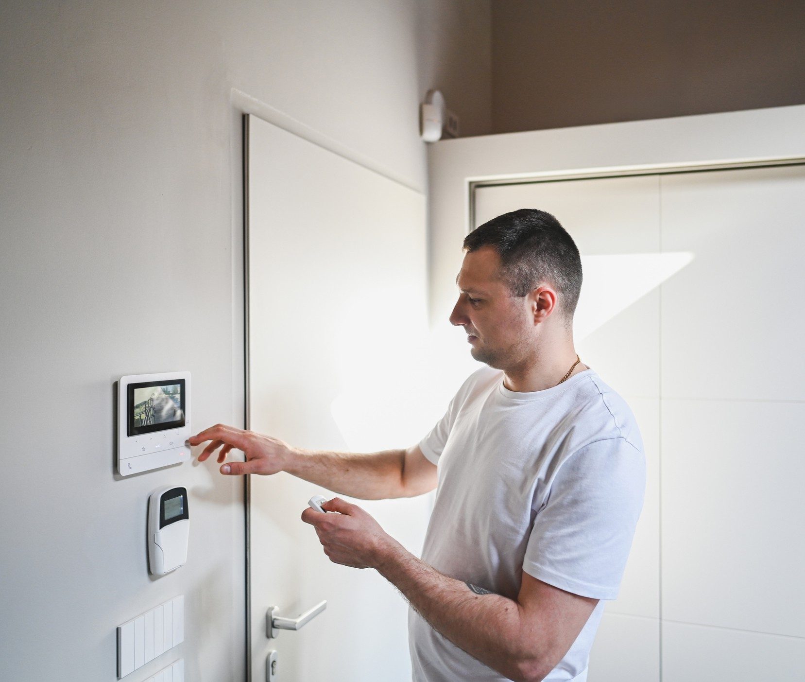Person setting digital thermostat