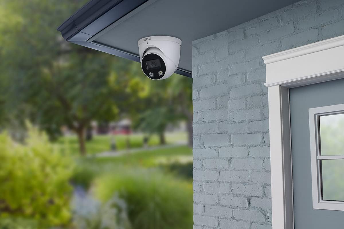A security camera mounted on a blue brick wall outdoors.