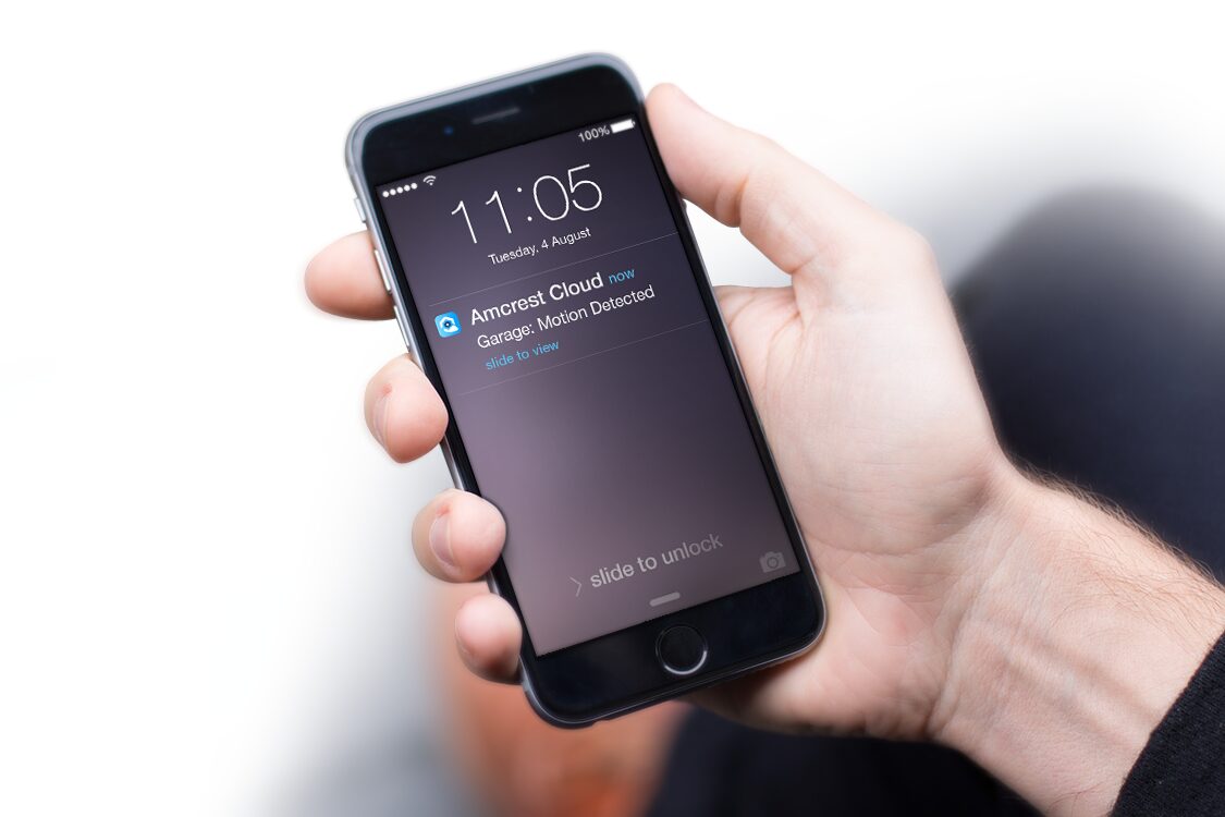 Hand holding a smartphone displaying a notification on the screen.