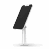A sleek white phone stand holding a smartphone upright.