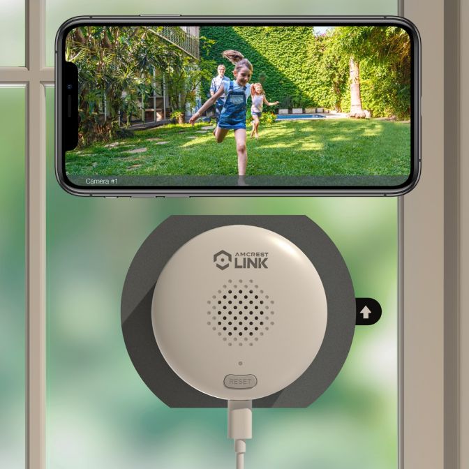 A phone on a circular charger displaying a person running in a park.