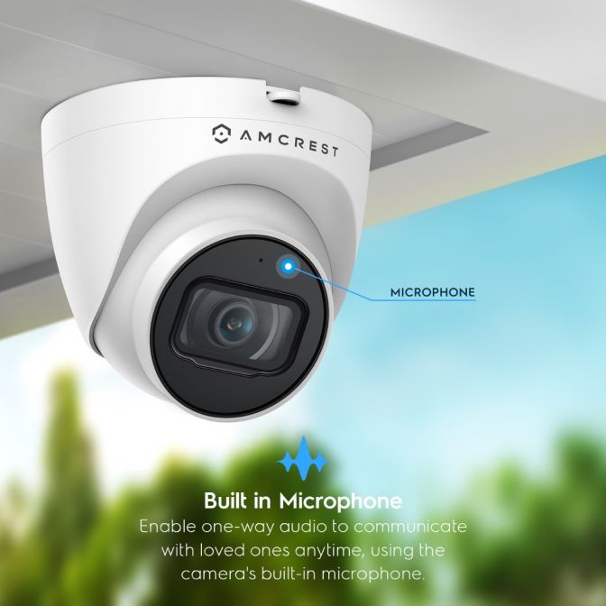 White security camera with built-in microphone on ceiling corner.