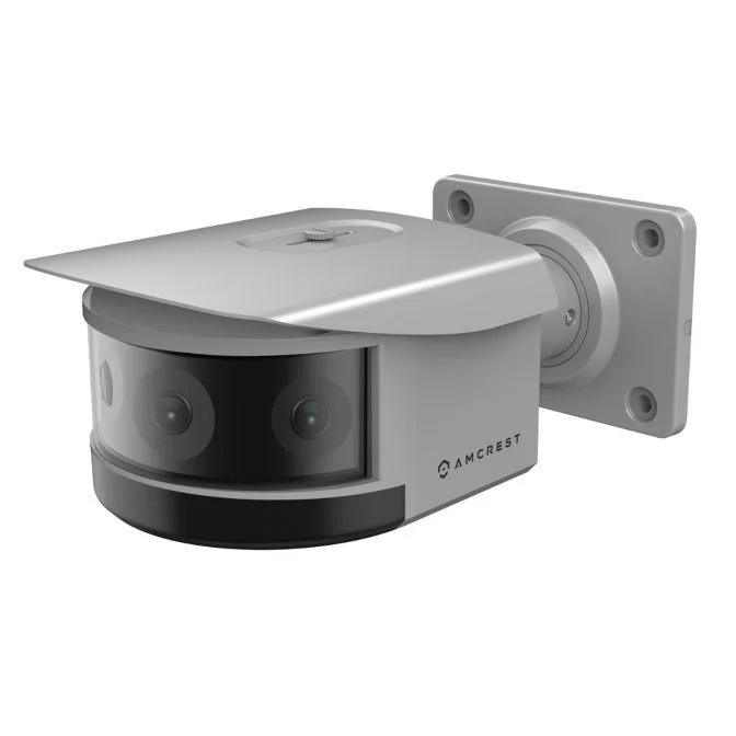 Wall-mounted security camera with protective cover.